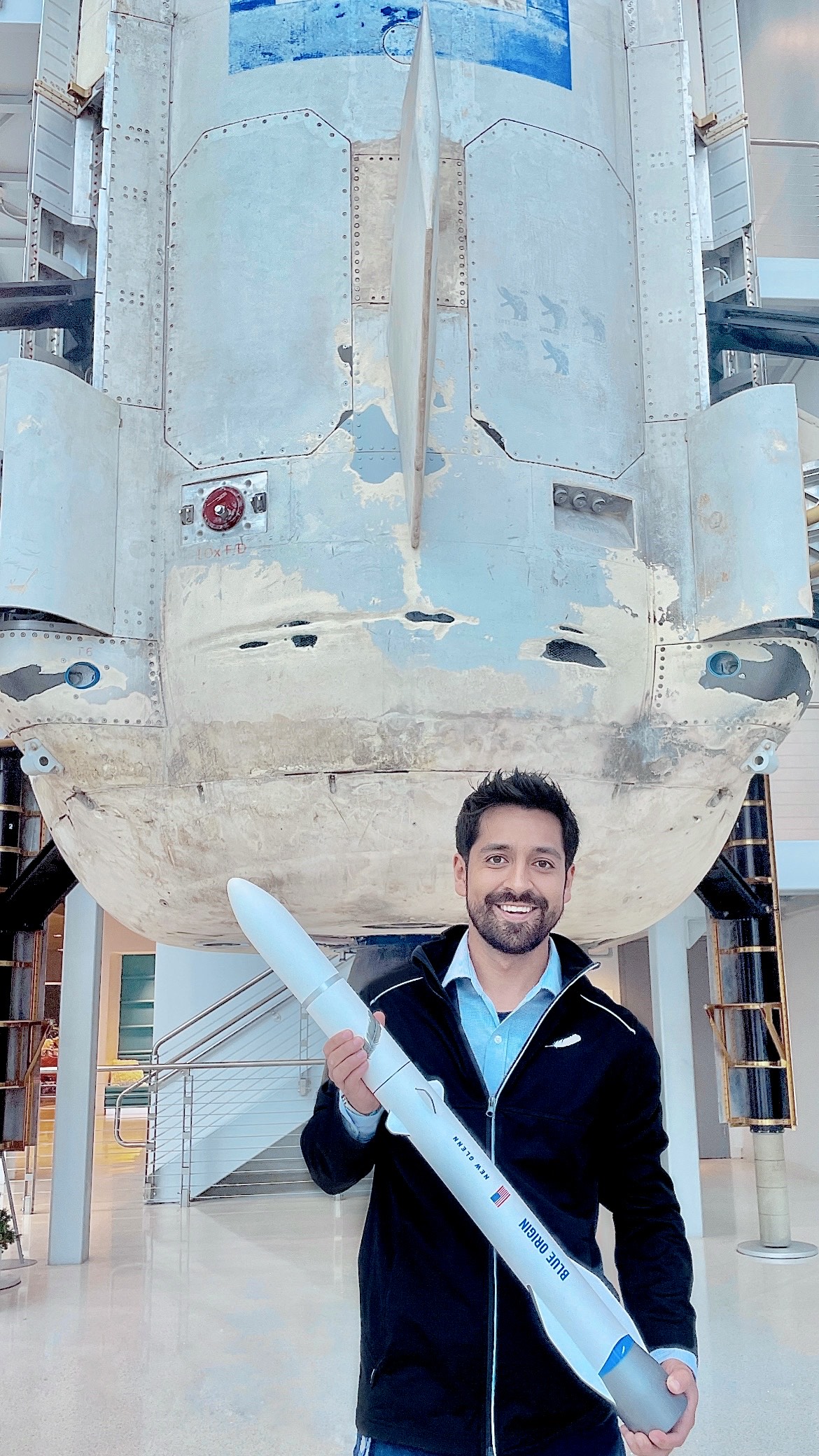 Tennessee Tech alumnus and Blue Origin engineer Ramon Sandoval Plascencia holds a model of the forthcoming New Glenn rocket. 