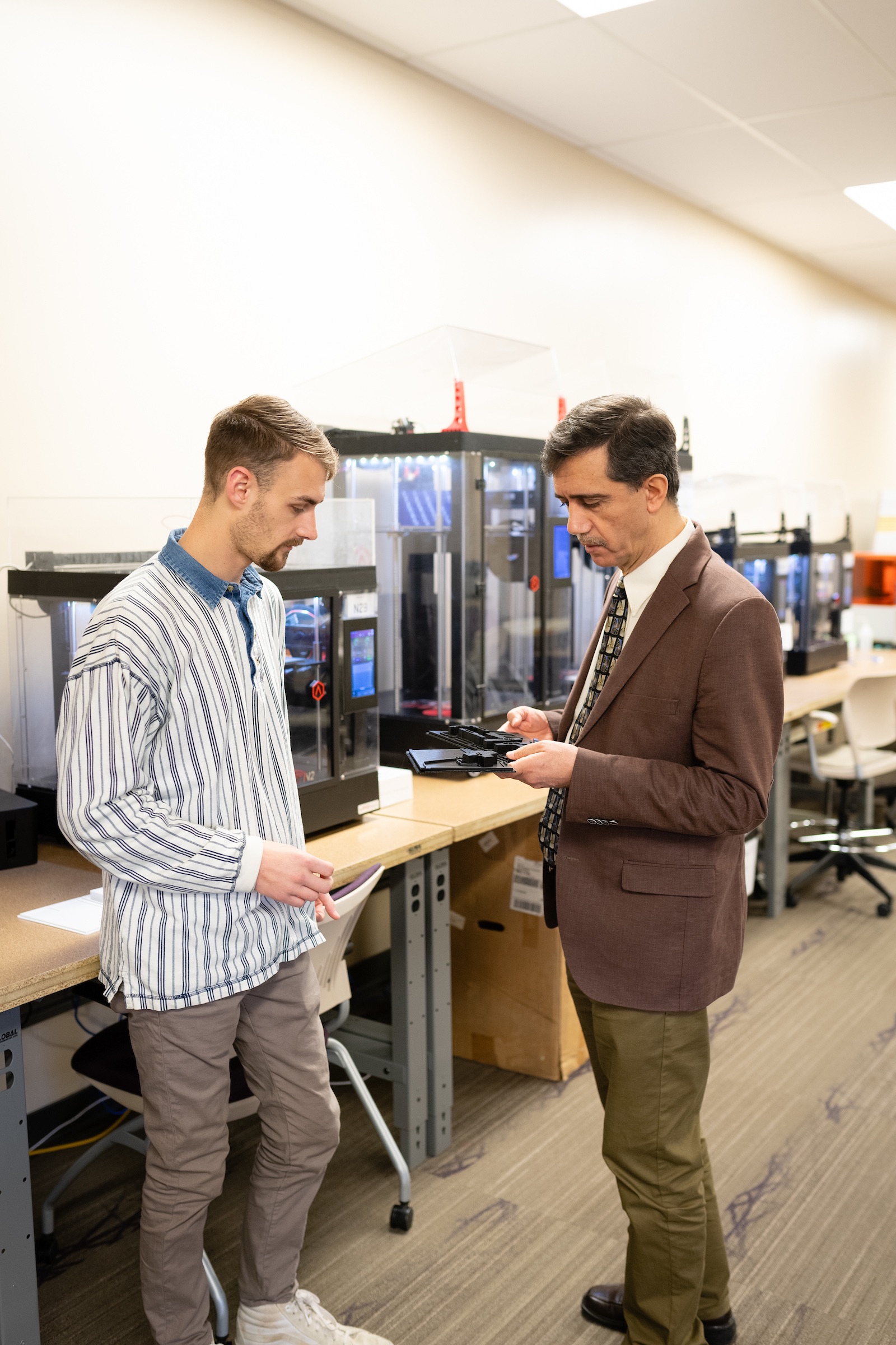 Professor Ismail Fidan speaks with a student in the iMakerSpace of Tech's Volpe Library. 