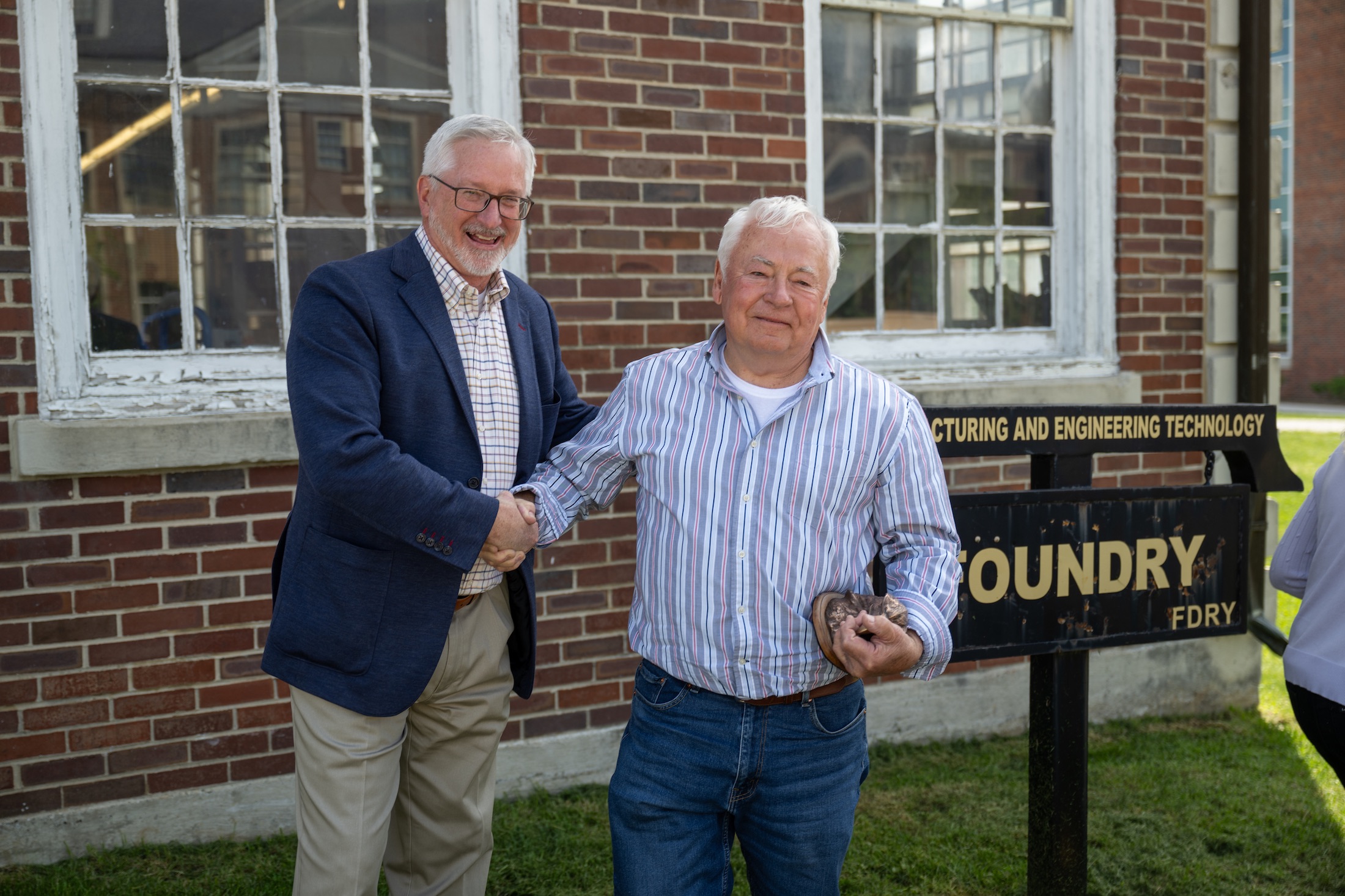From left: Tech President Phil Oldham and former Tech student Gary Durham shake hands following Oldham’s announcement that Tech’s new foundry will be named in Durham’s honor. 