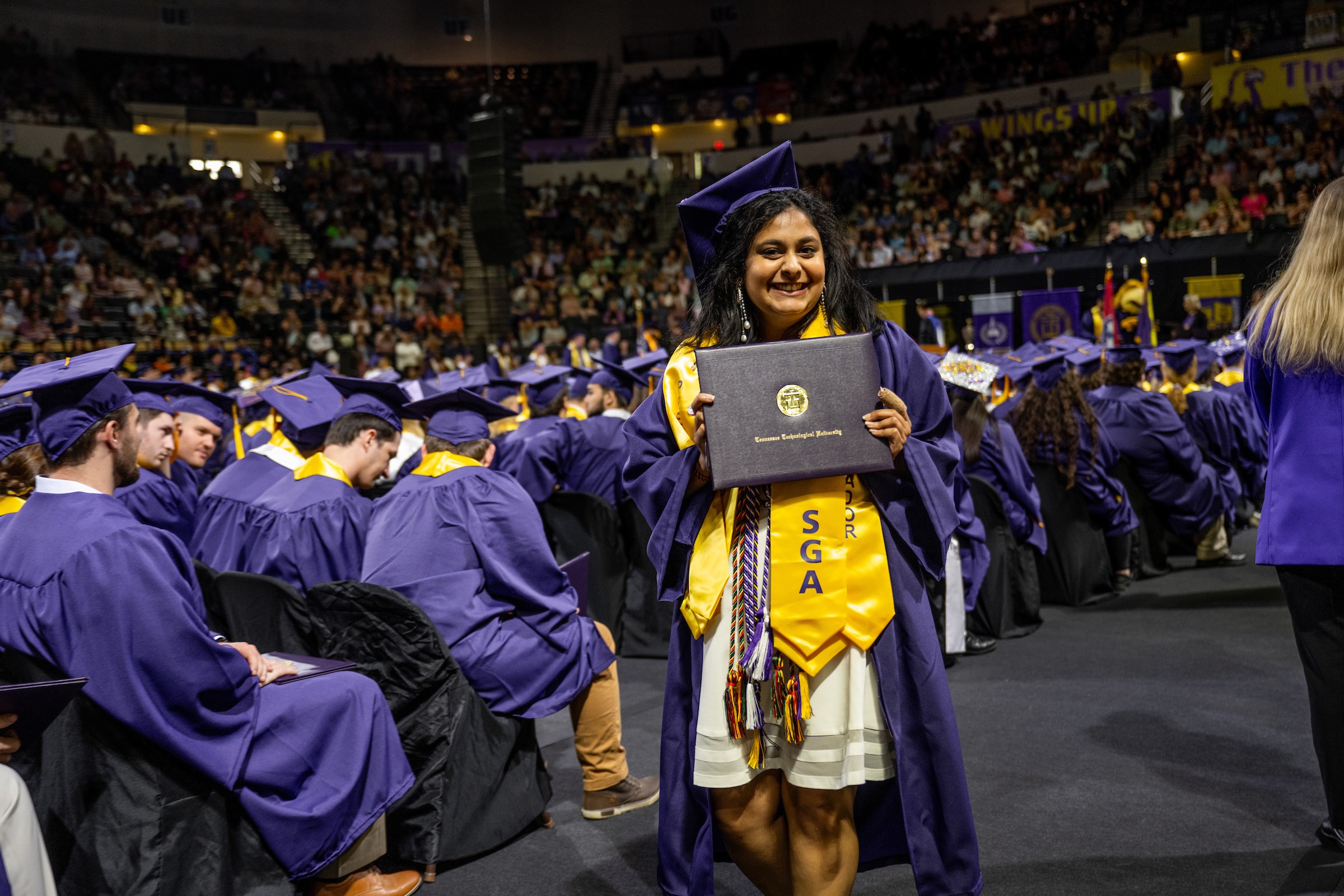 Tech College of Engineering graduate Pooja Patel smiles with her degree in hand.