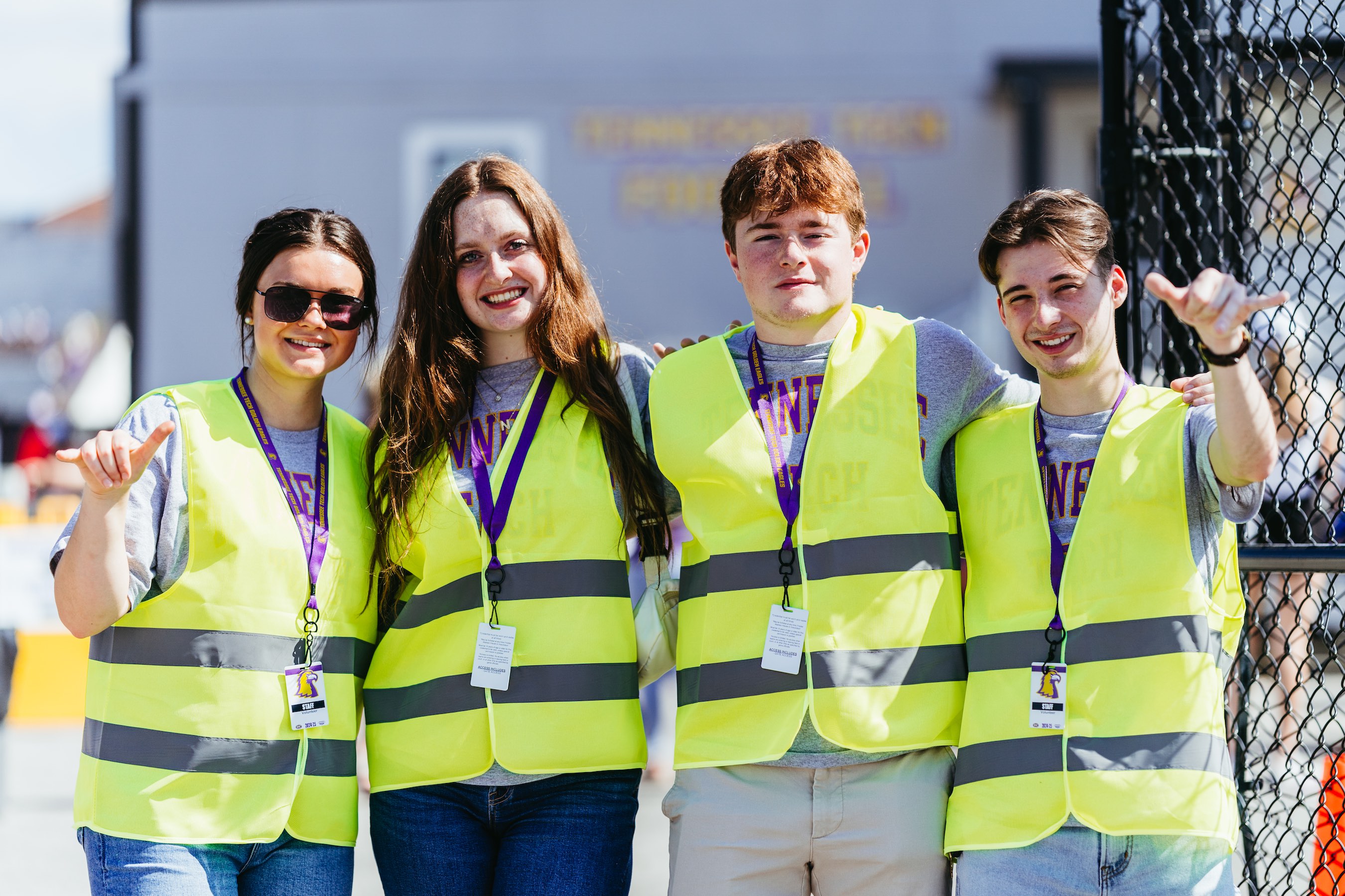 Tech students in Lecturer Chelsea Dowell’s sports economics class volunteer at a Tech football game. From left: Sara England, Natalie Halfacre, Will Halfacre, and Charles Jones. Photo by Emily Armstrong.  Tech students in Lecturer Chelsea Dowell’s sports economics class volunteer at a Tech football game. From left: Sara England, Natalie Halfacre, Will Halfacre, and Charles Jones. Photo by Emily Armstrong.