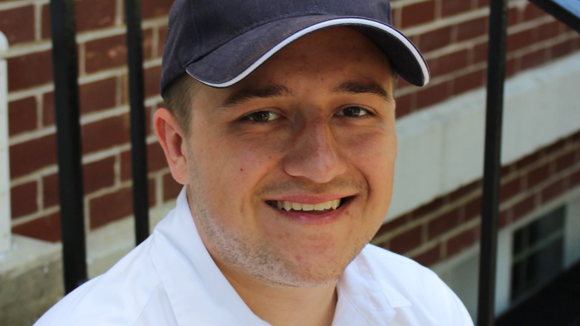 Tanner Cox  Tanner Cox wears a hat and smiles.