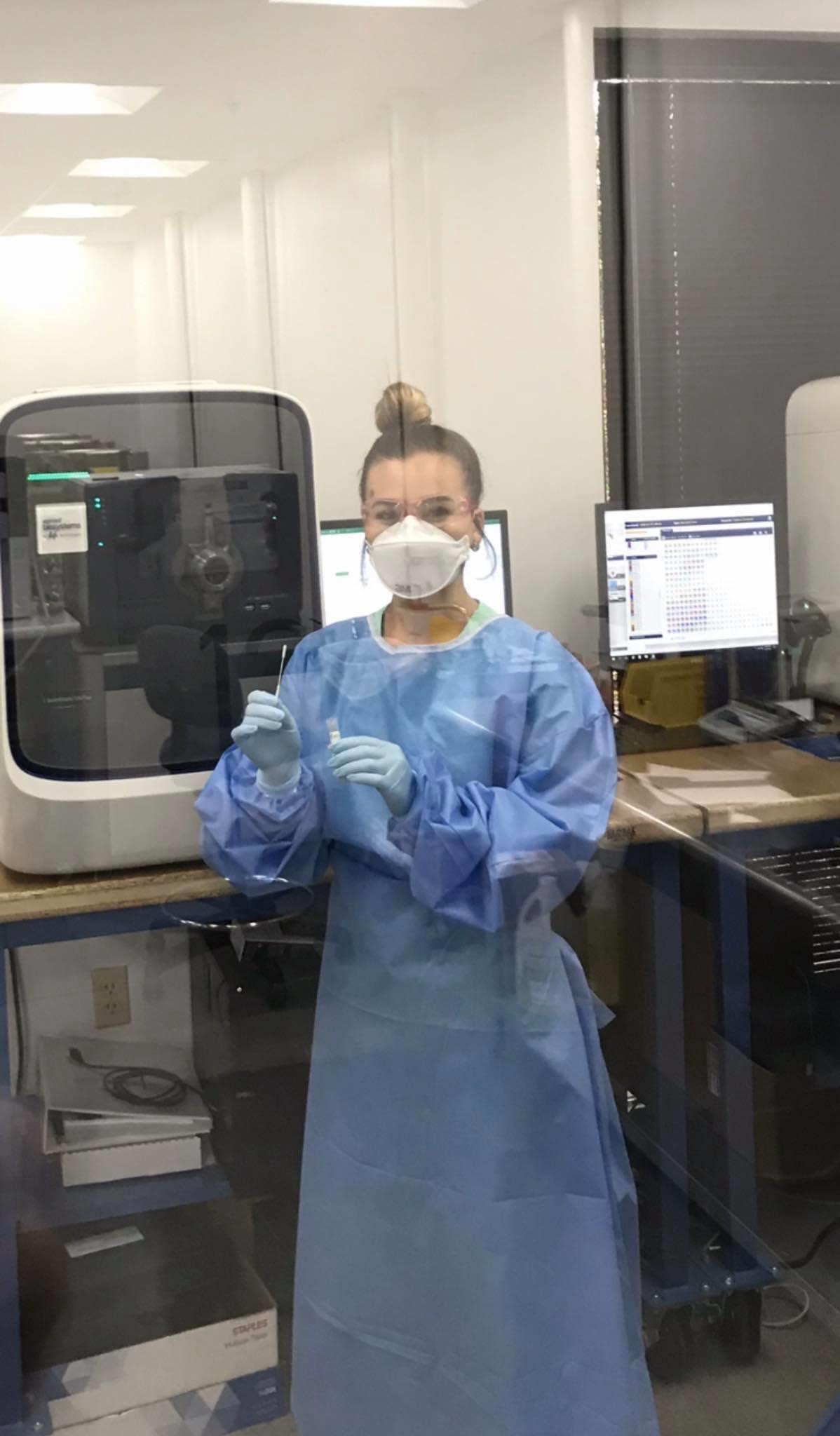 Amber Monroe, a Tennessee Tech chemical engineering alumna, shows off one of the COVID-19 tests in Integrity Laboratories in Knoxville.