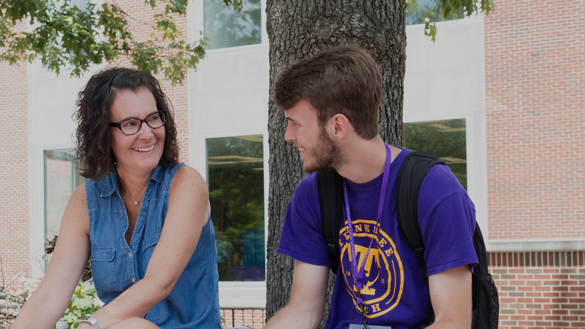 parent and student smiling at one another