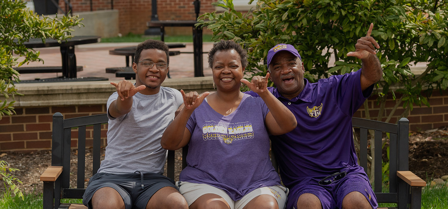 family giving wings up hand sign