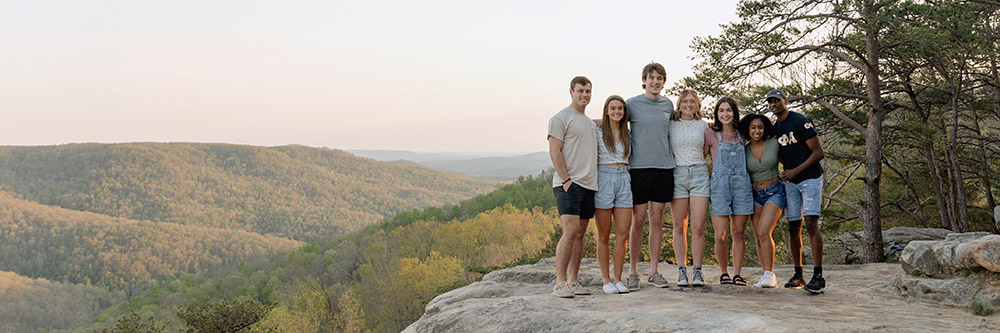 A group of students posing at am outdoor park.