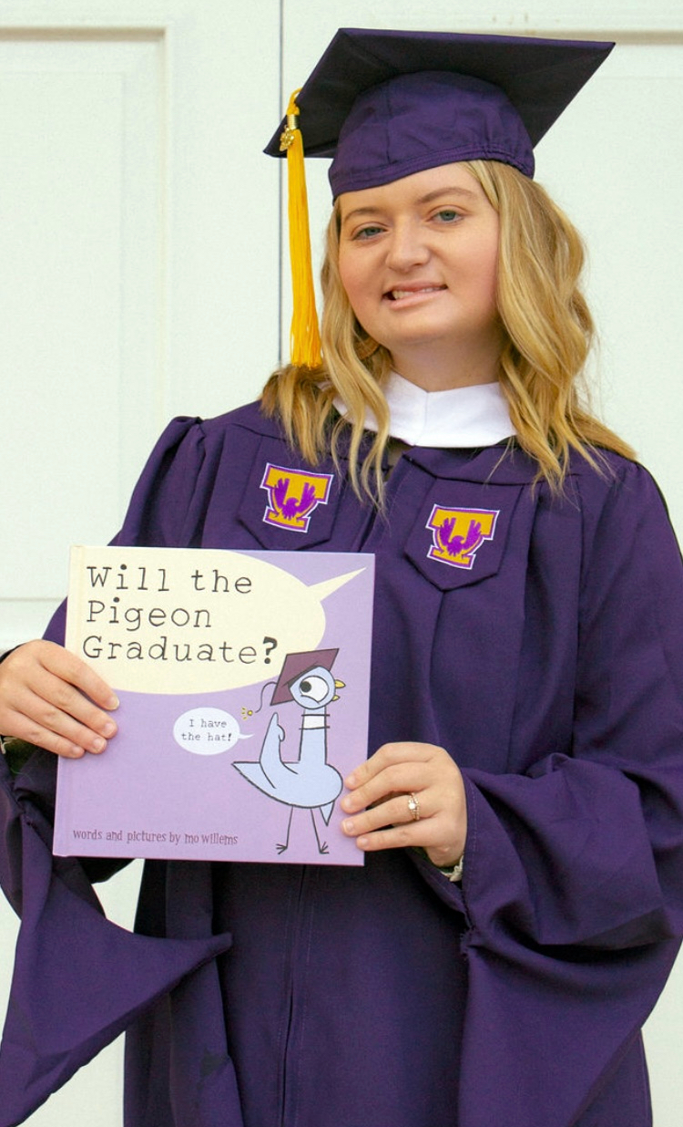 Kylee Niec stands in her cap and gown, holding her diploma from Tennessee Tech.