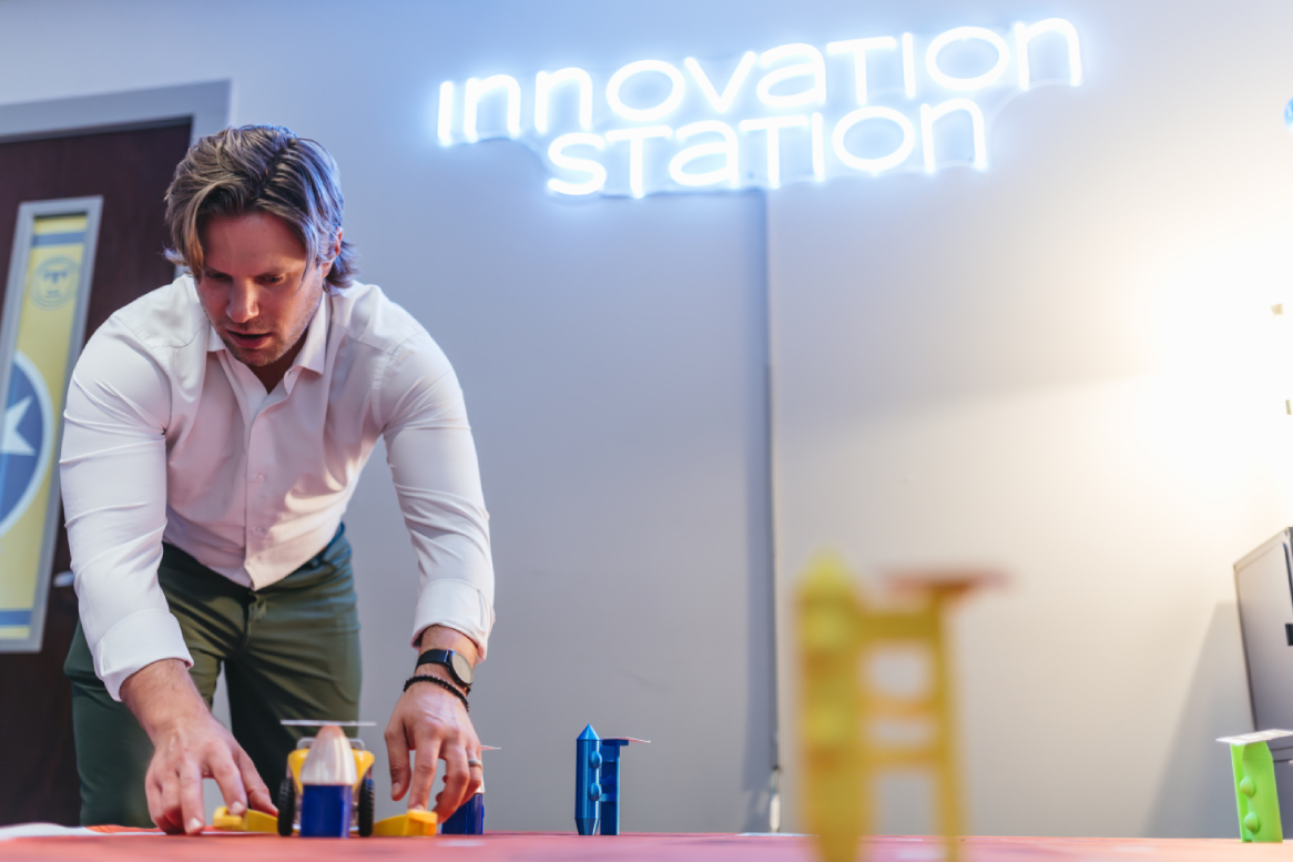 Cory Gleasman sets up miniature robots as part of Mars Mission.