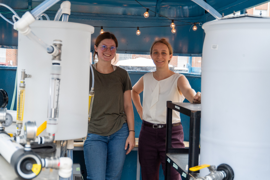 Laura Arias Chavez and Catherine Murphy stand with their equipment.