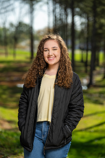 Portrait of Farrah Meredith on the walking trail behind Foundation Hall