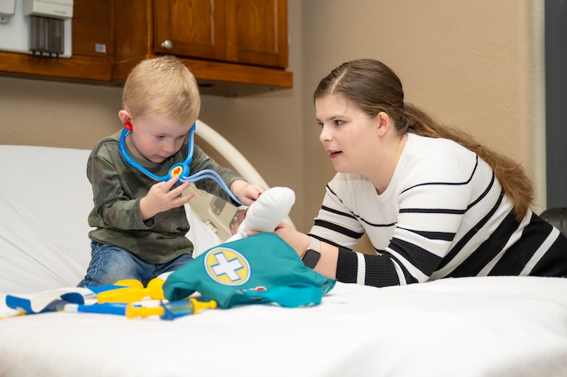 Kaelyn Adams with child in a hospital scence