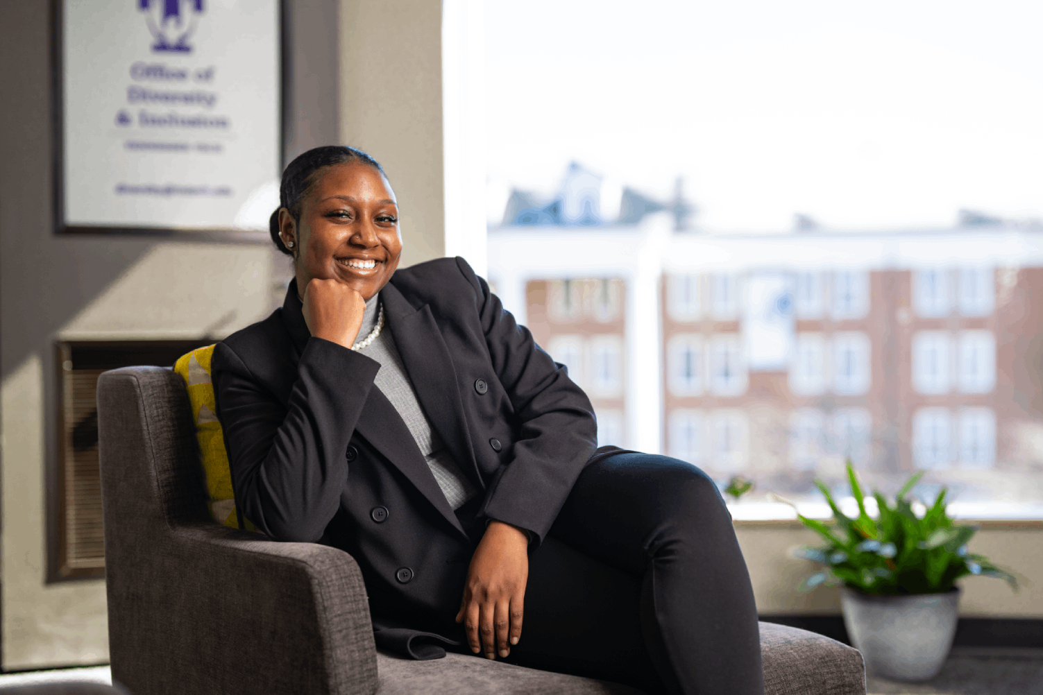 Autezia Sellers sits beside a large window overlooking Tech's campus.