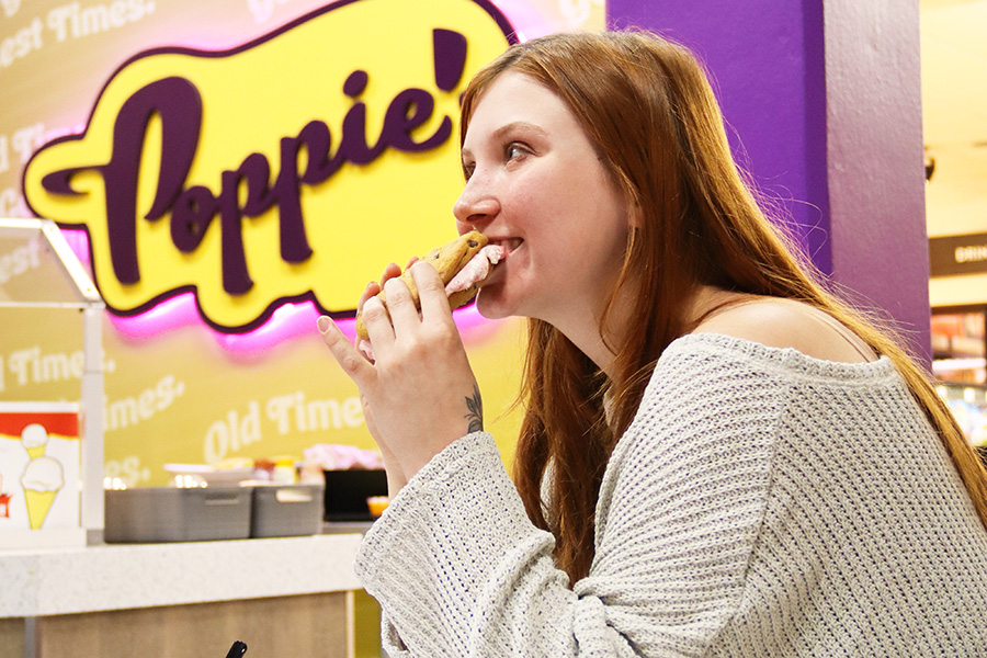 A student eating an ice cream sandwhich at Poppie's
