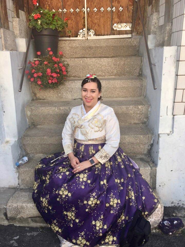 Girl cheesing on the steps.