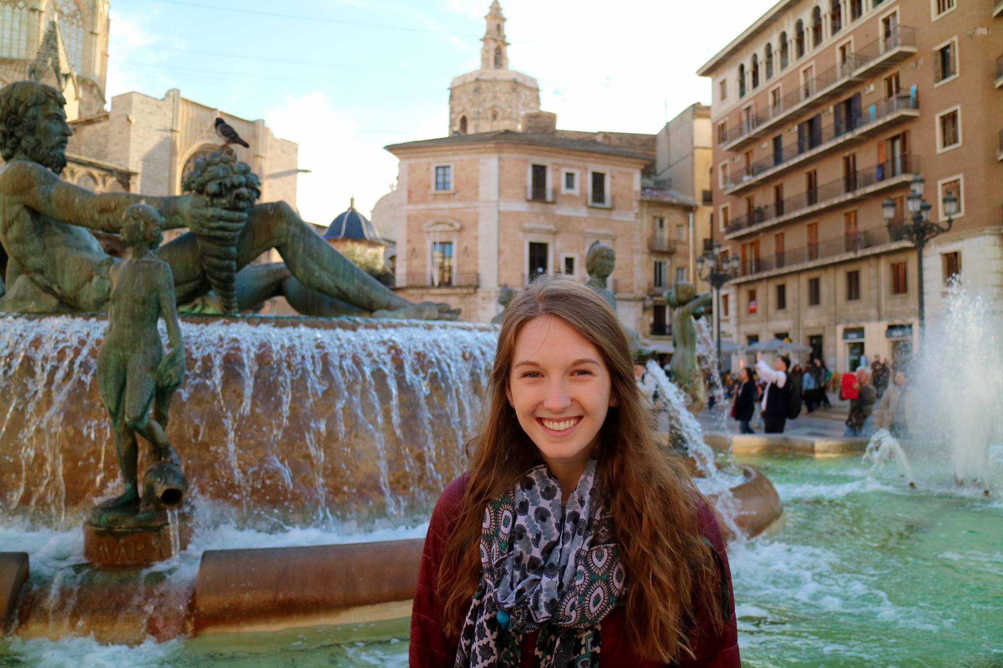 student smiling in front of an italian fountain
