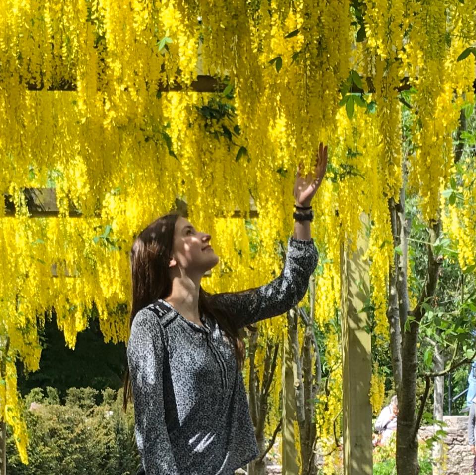 Girl under yellow tree.