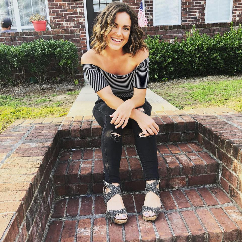 GIrl posing on the steps.