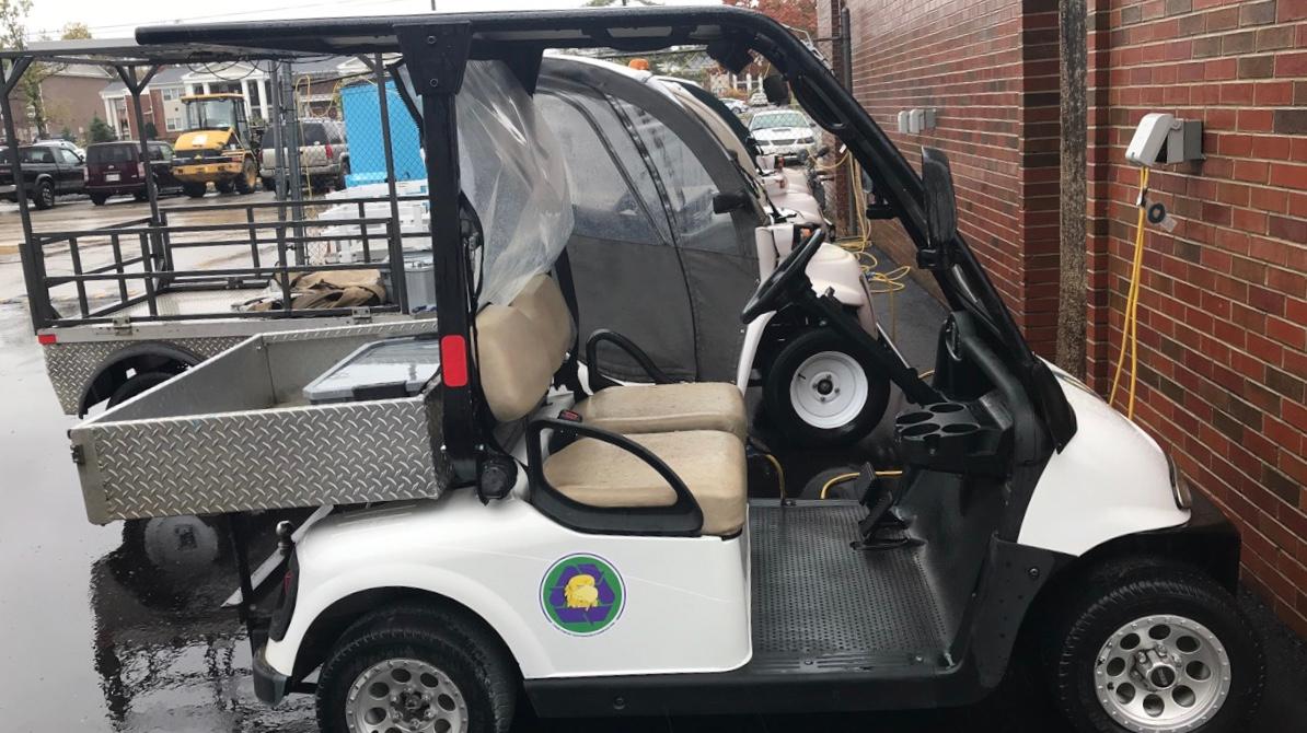 Electric golf cart on campus charging 
