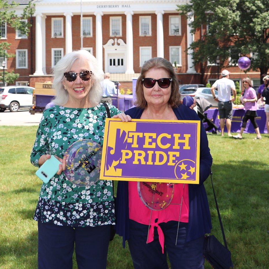 Donna Porter and friend smile and show their Tech Pride  