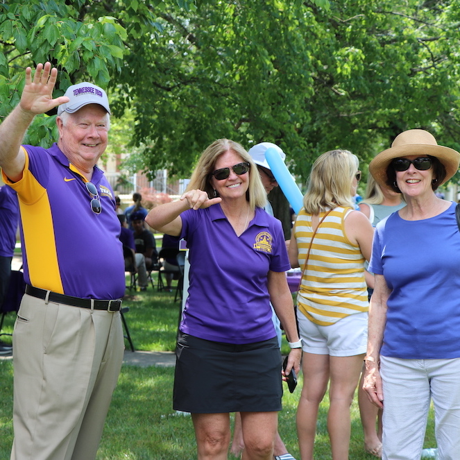 Former Tech President Bob Bell, Becky Magura, and Gloria Bell give "wings up." 