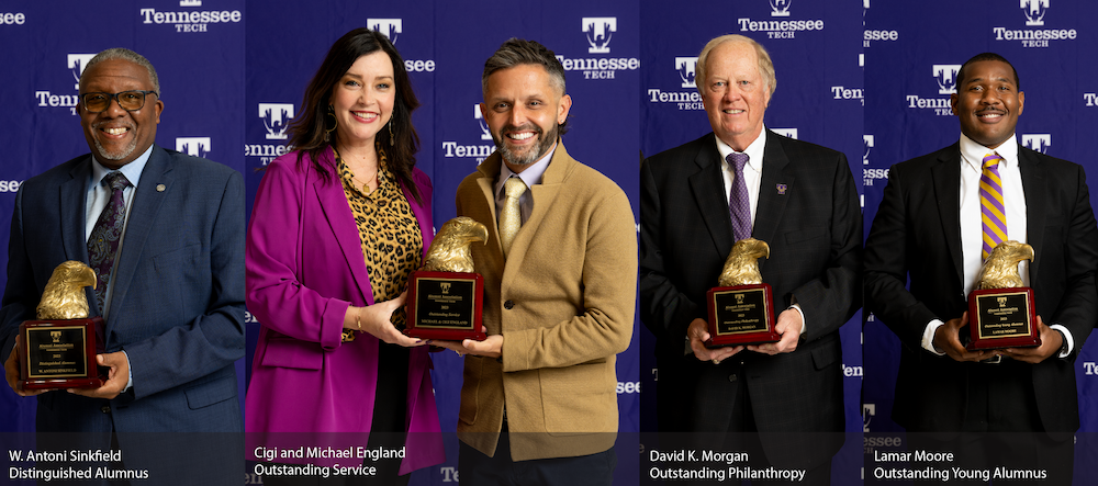 The awards receipients smile with their statuettes. 