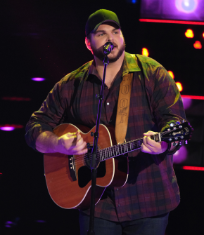 Jake Hoot singing with a guitar