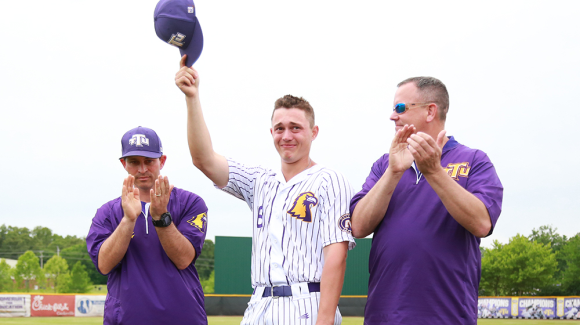 Kevin Strohschein holding his hat up as he completes his Golden Eagle career.