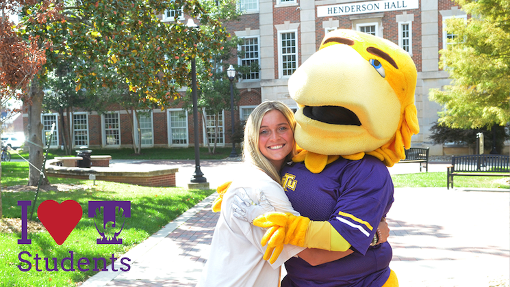 A student hugging Awesome Eagle