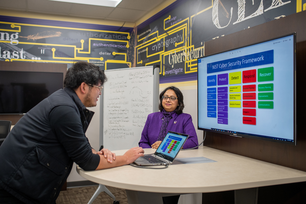 Dr. Siraj speaks to a student in CEROC.