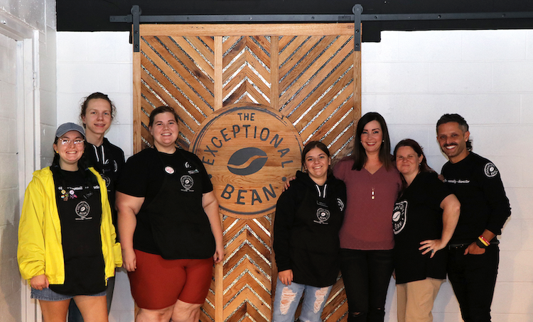 Michael and Cigi England pose with employess of the Exceptional Bean.