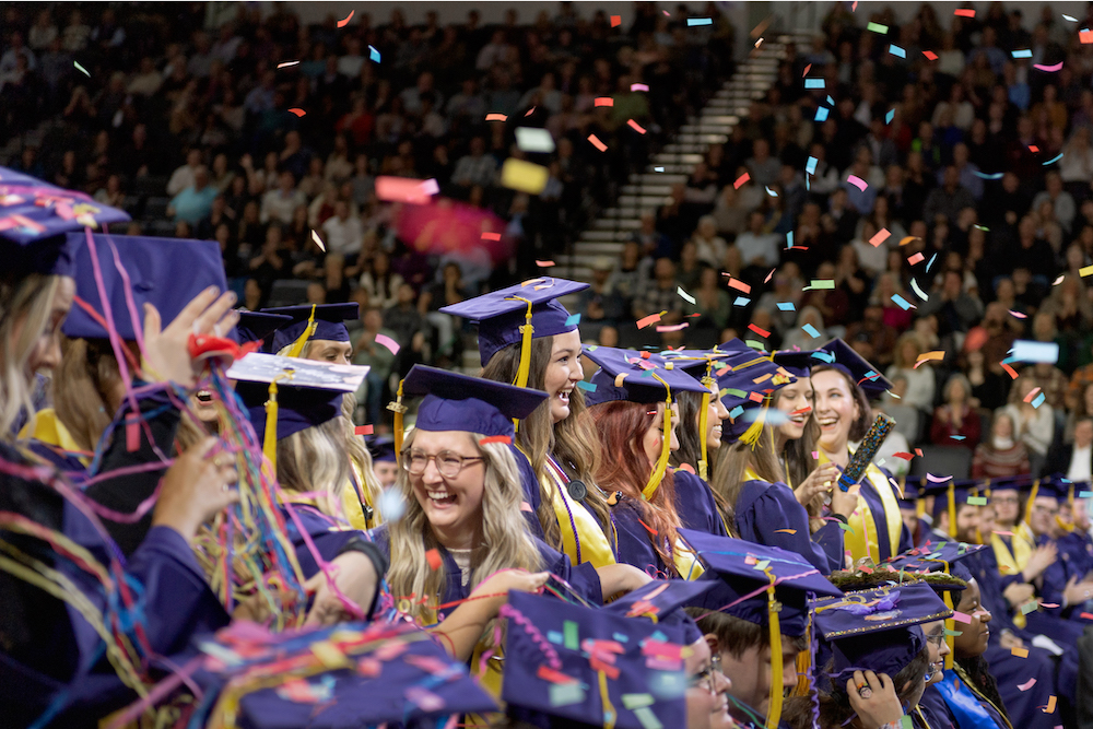 Students in caps and gowns at commencement.