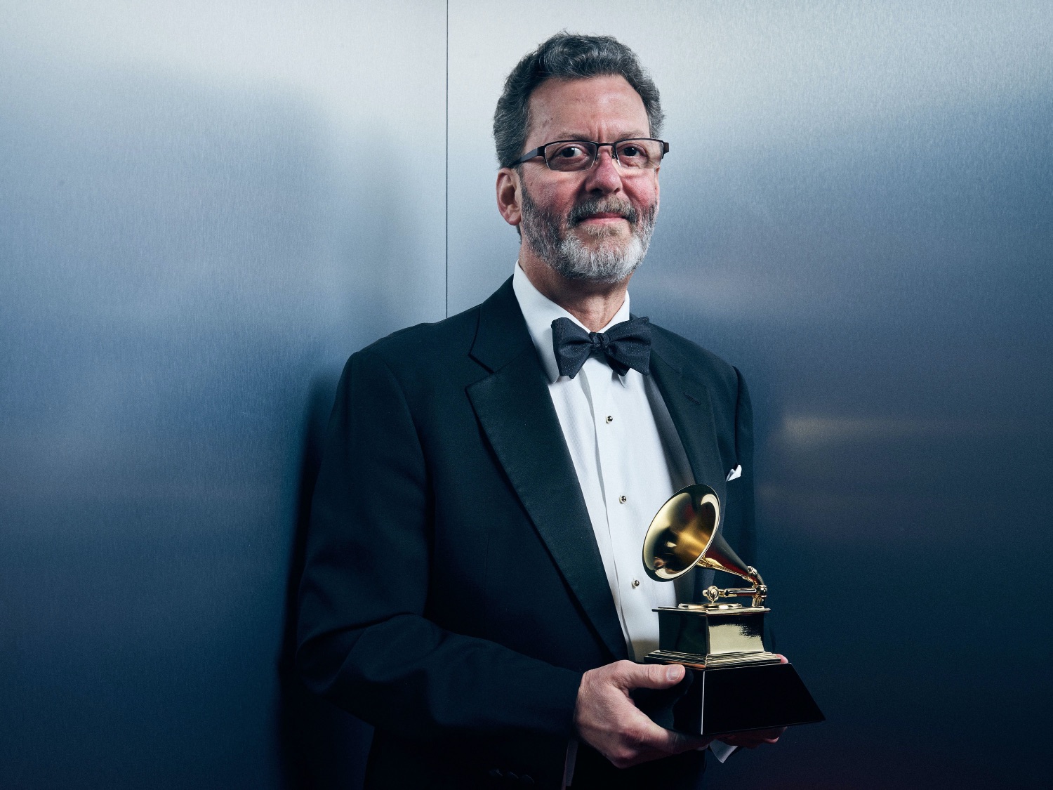 a portrait of Blanton Alspaugh holding a Grammy