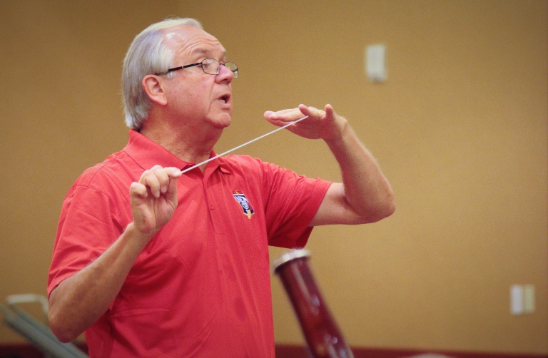 a photo of Joseph Hermann with a conductor's baton