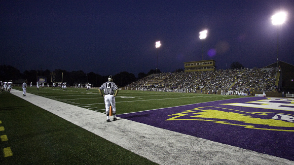 Referee on the sideline of a football game in Tucker Stadium.