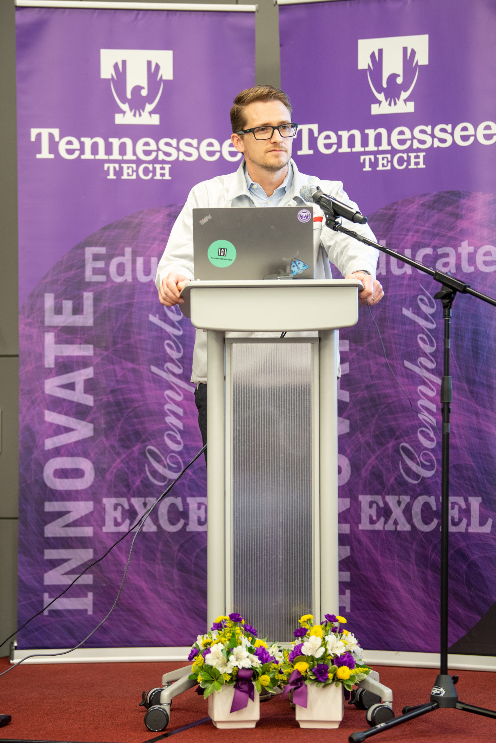 David Johnson stands at a lecturn in front of a Tennessee Tech backdrop.