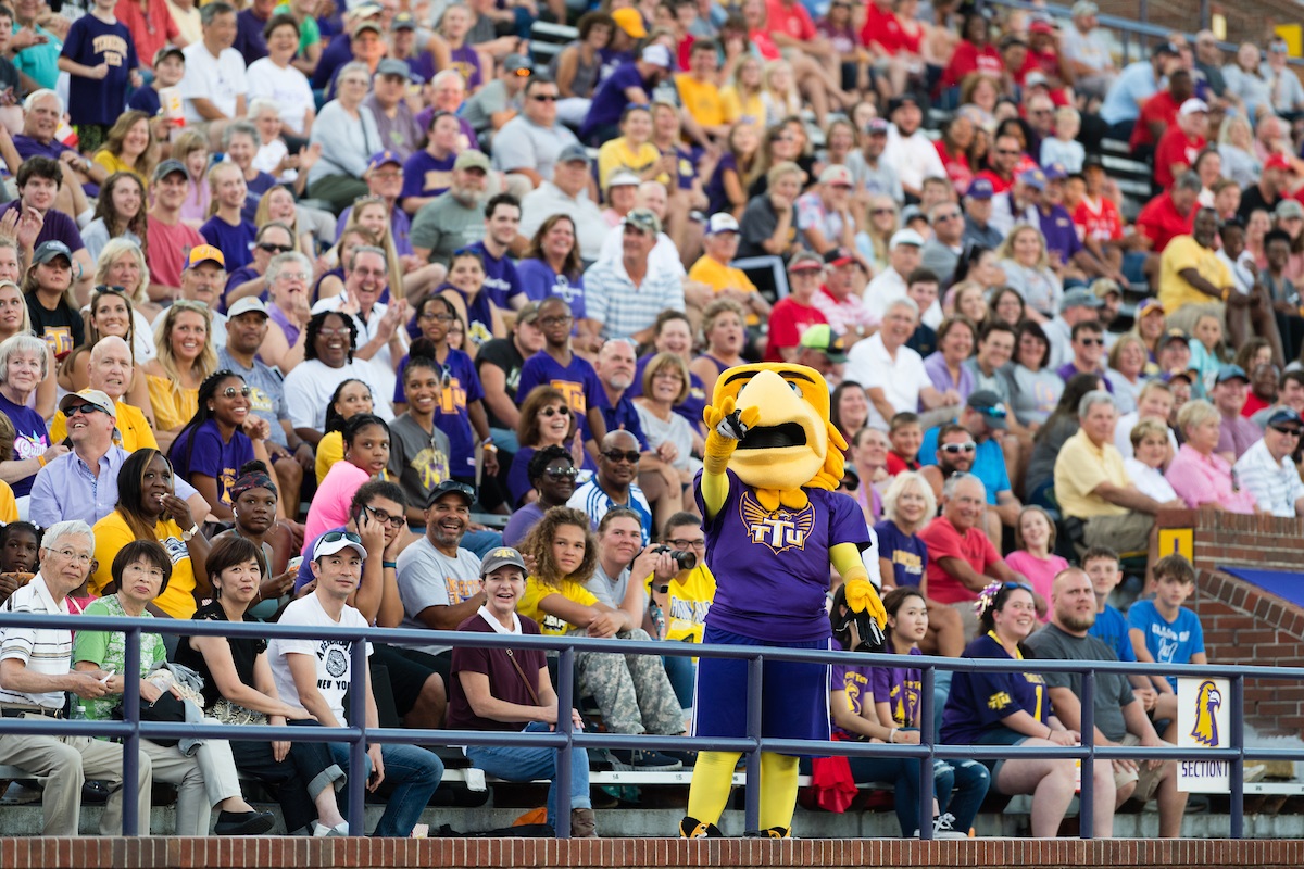 Awesome stands in front of a crowd of onlookers at Tucker Stadium