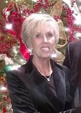 A snapshot of Shelia Green in front of a Christmas tree.