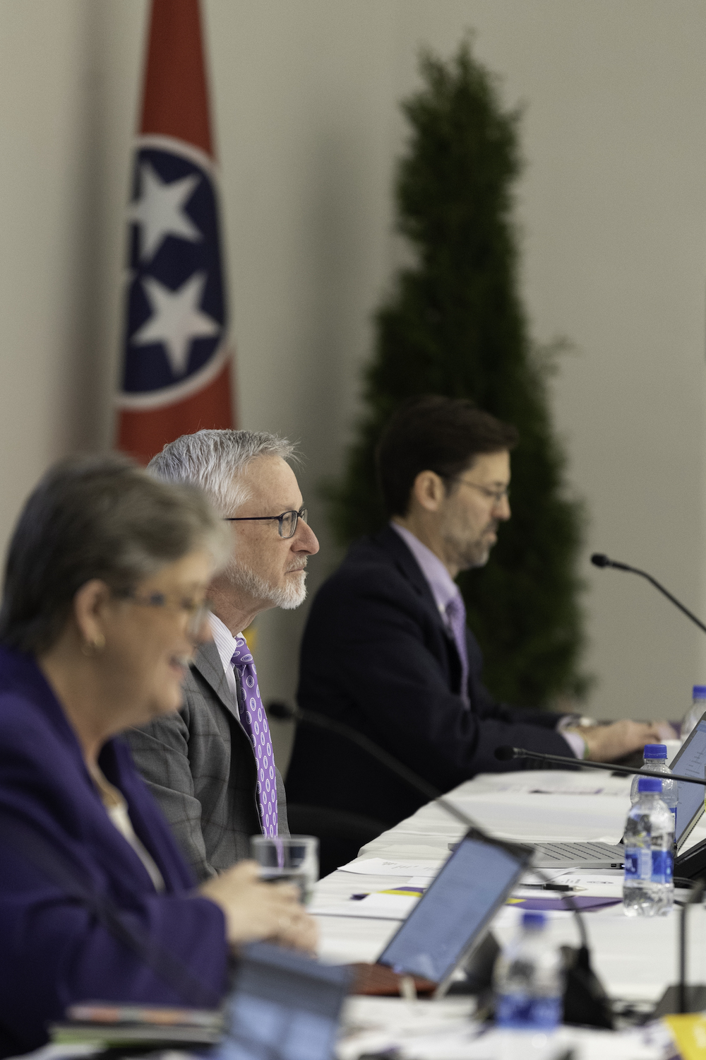 a photo of board of trustee members sitting at a table