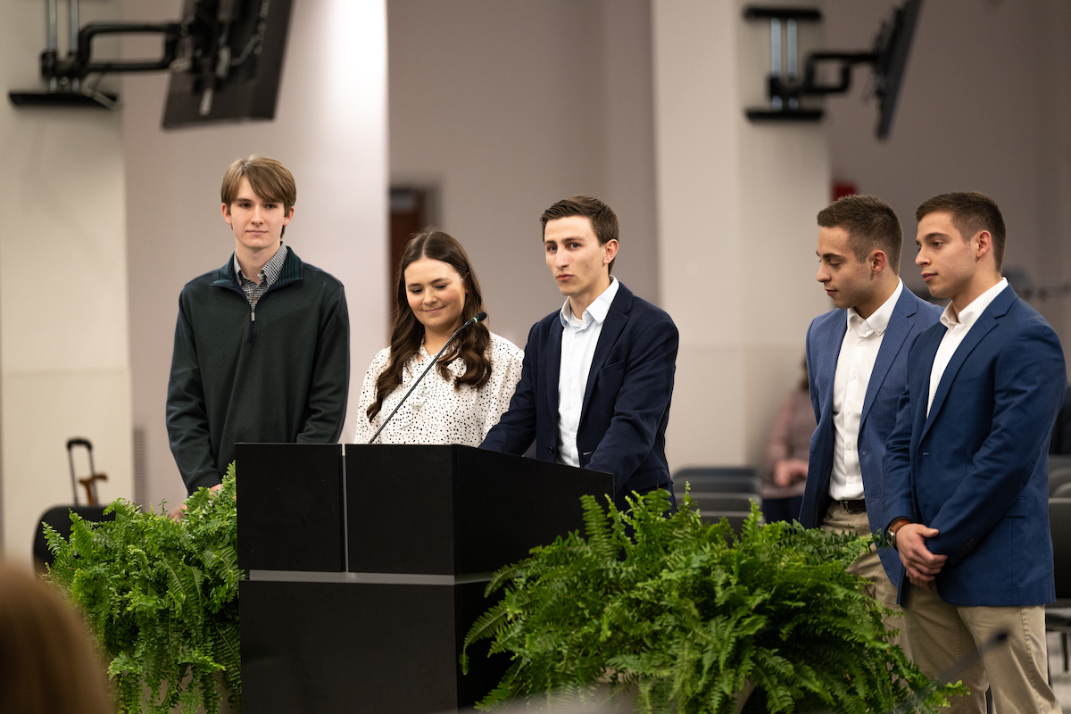 A group of students at a lecturn