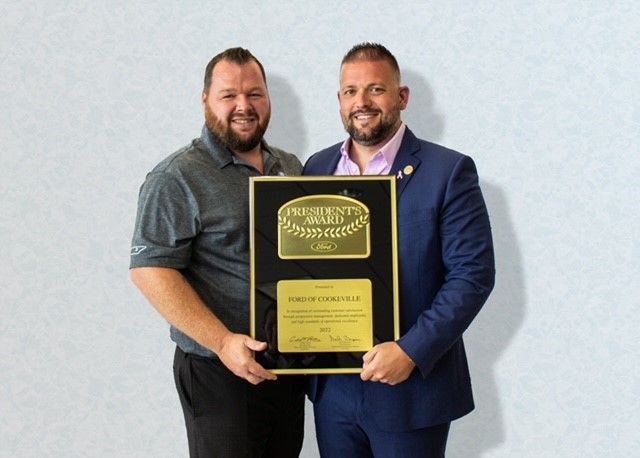 Employees of Ford Lincoln holding a plaque