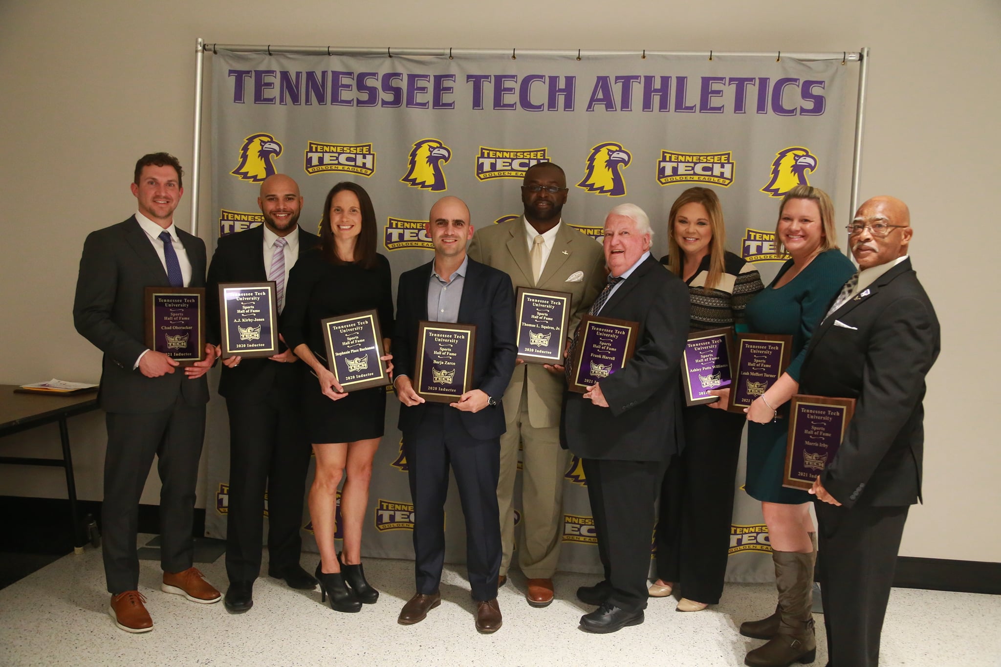 Hall of Fame inductees pose with their plaques