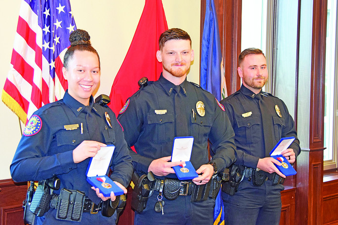 Alannah Davis receives a medal with two of her colleagues.