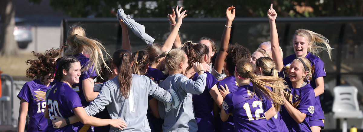 Women's soccer celebrating on the field