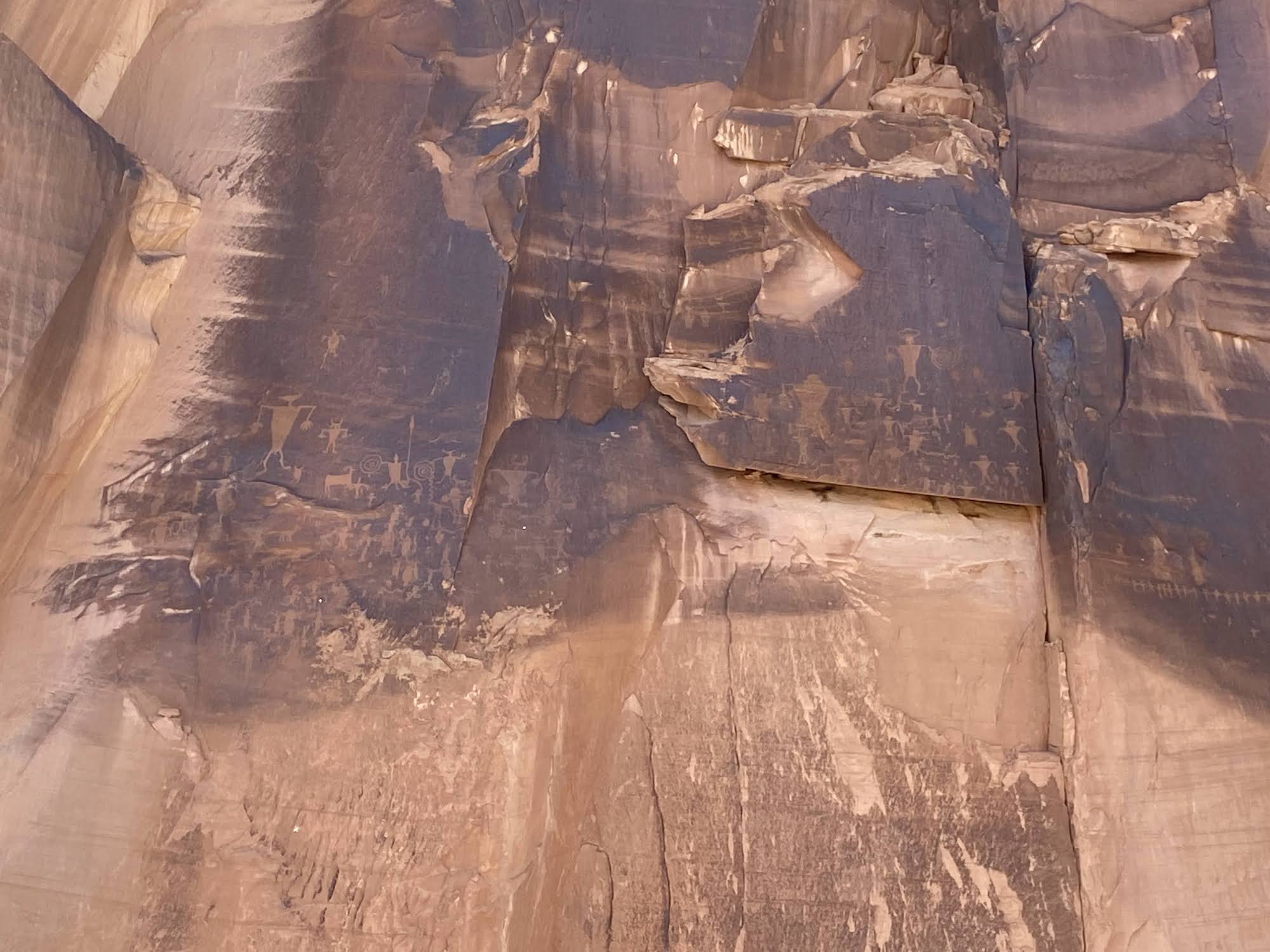 Petroglyphs etched in the black staining on red sandstone