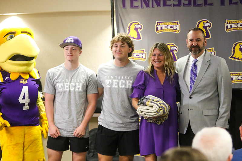 Casey Fox stnading with family during the announcement press conference. 