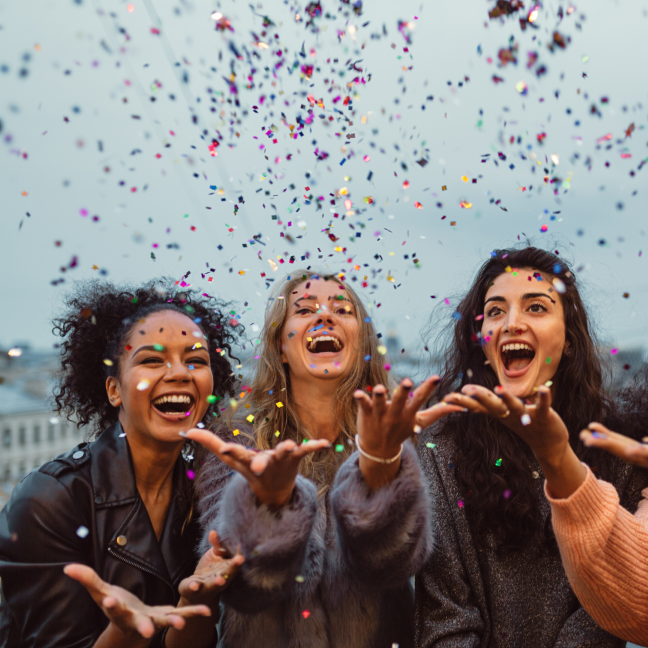 women celebrating with confetti